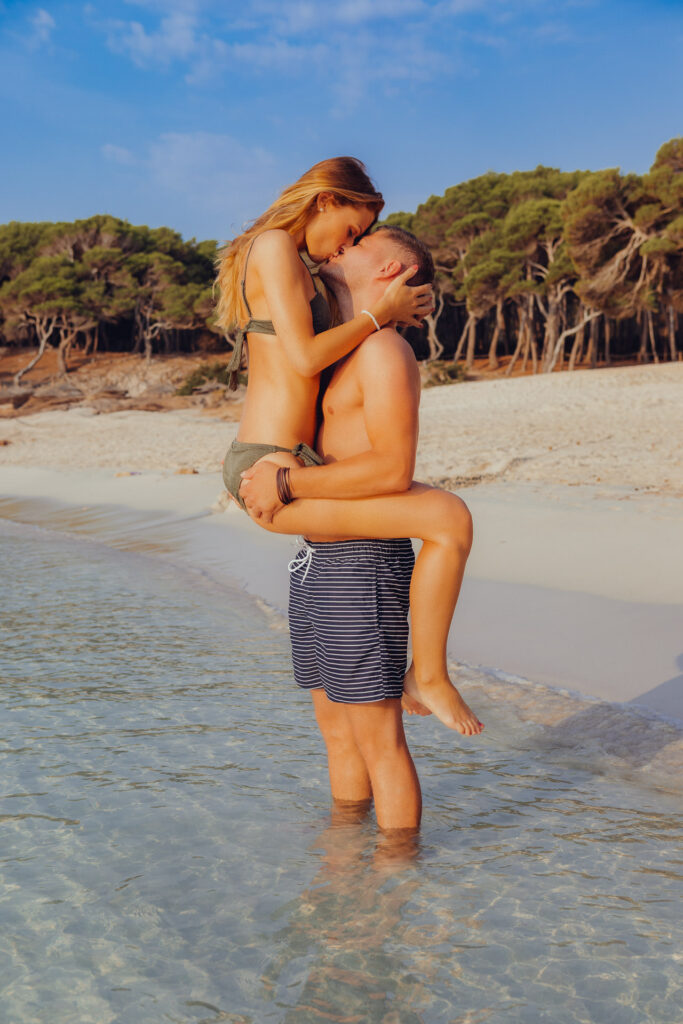 Verliebtes Pärchen küssen sich am Strand von Cala Rajada